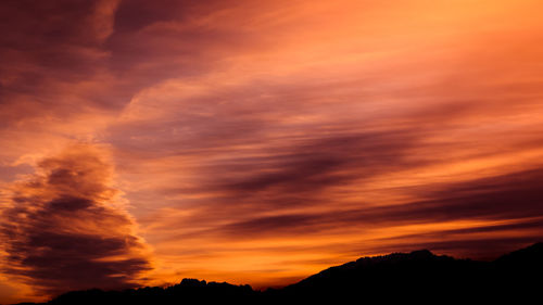 Low angle view of dramatic sky during sunset