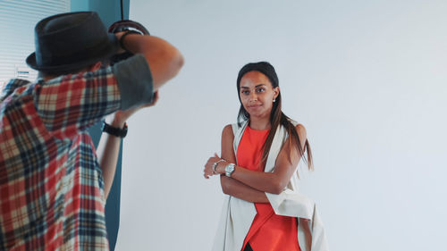 Portrait of friends standing against white background