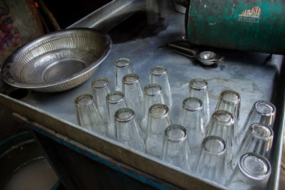 Close-up of glass tumblers and steel utensils on a table