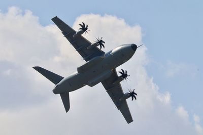 Low angle view of airplane flying in sky