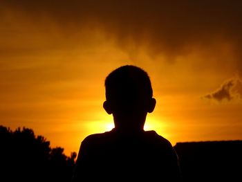 Silhouette man against sky during sunset