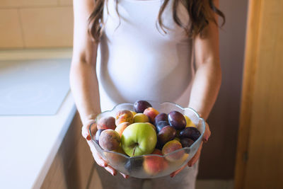 Close-up of hand holding fruit at home