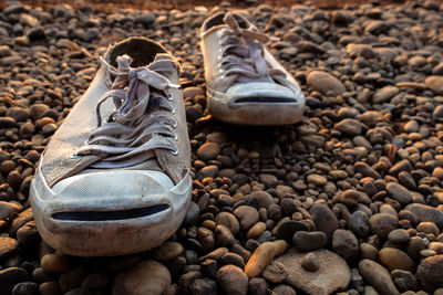 Close-up of shoes on stone