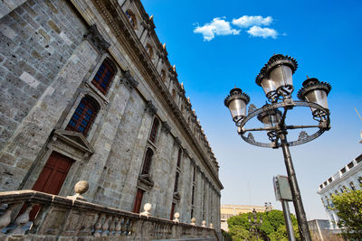 Low angle view of street light against building