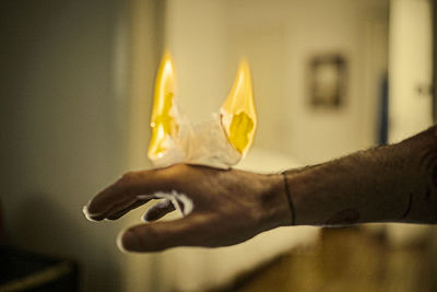 Close-up of hand holding yellow light painting