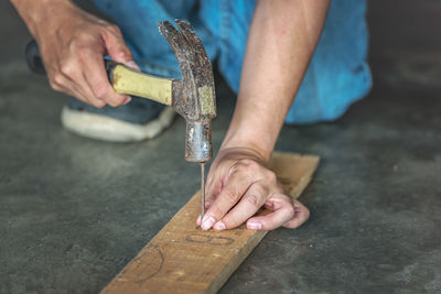 Midsection of man working on wood