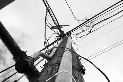 Low angle view of electricity pylon against sky