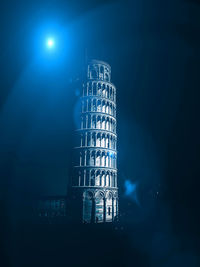 Low angle view of illuminated building against sky at night