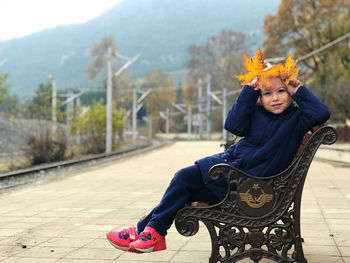 Portrait of happy girl sitting outdoors