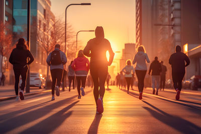 Rear view of people walking on road