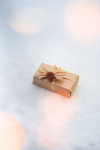 High angle view of gift box on snow