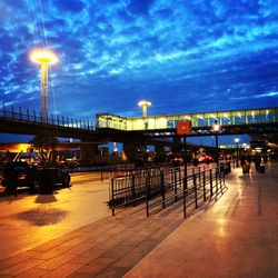 Illuminated street lights against sky at night
