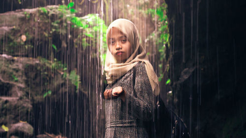 Portrait of girl standing in forest