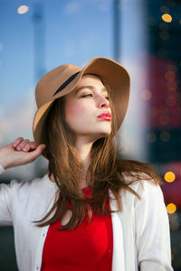 Portrait of young woman wearing red shirt and lipstick