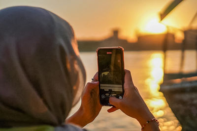 Midsection of man photographing with camera