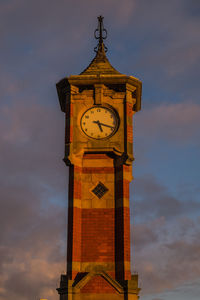 Low angle view of clock tower against sky