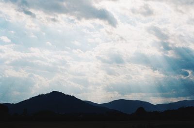 Scenic view of silhouette mountains against sky