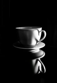 Close-up of coffee cup against black background