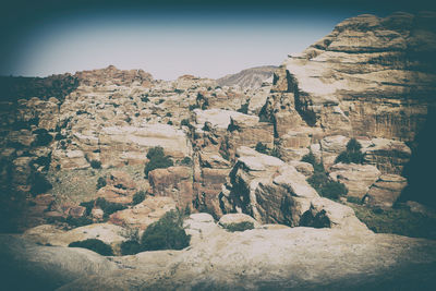 Rock formations on landscape against sky