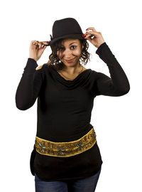 Portrait of young woman standing against white background