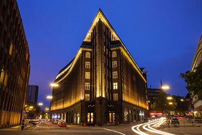 Road along buildings at night