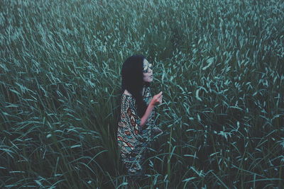 Young woman standing on field