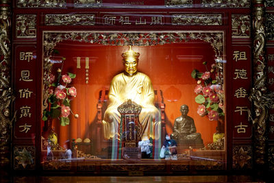 Statue in temple against building