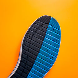 Close-up of electric lamp against orange background