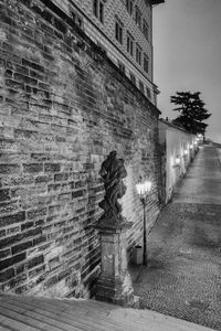 Statues on wall of building in city