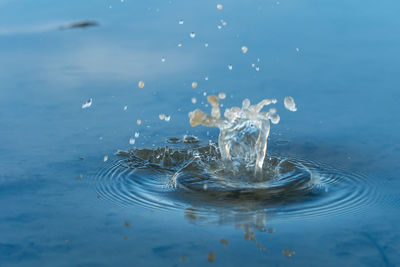 Close-up of water splashing against blue background