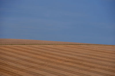 Scenic view of field against blue sky