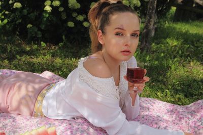 Portrait of young woman drinking drink