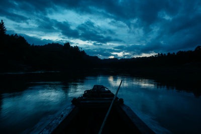 Scenic view of lake against sky at dusk