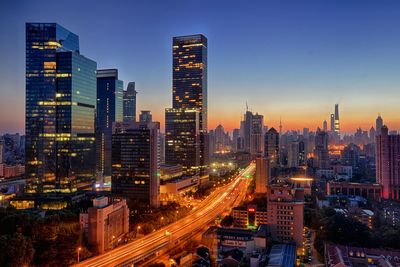 Skyscrapers in city during sunset