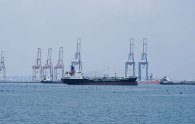 Commercial dock by sea against sky