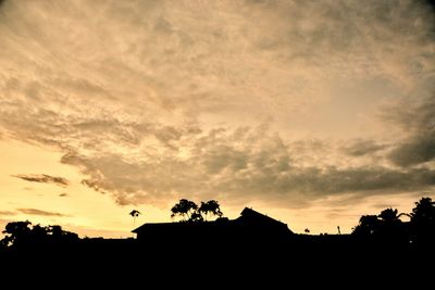 Low angle view of silhouette trees against sky