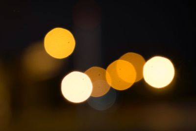 Defocused image of illuminated yellow lights