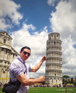 Full length of man standing by tower against sky