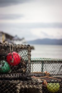 Close-up of rope on metal railing against sea