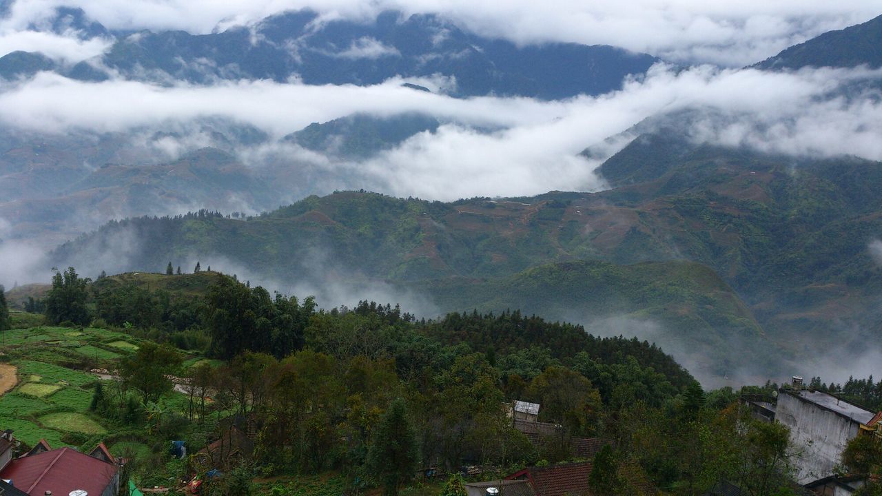 mountain, tree, scenics, mountain range, sky, beauty in nature, landscape, tranquil scene, building exterior, tranquility, built structure, architecture, nature, house, high angle view, fog, weather, cloud - sky, idyllic, non-urban scene
