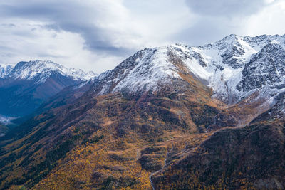 View from above on the slopes of the mountains, overgrown with forest in autumn. mountains, tourism.