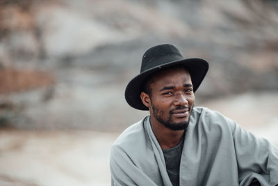 Portrait of young man looking away outdoors