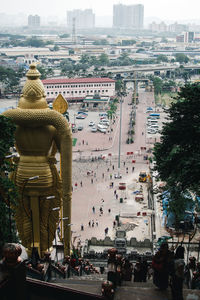 Statues on street amidst buildings in city