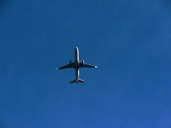 Low angle view of airplane flying in clear sky