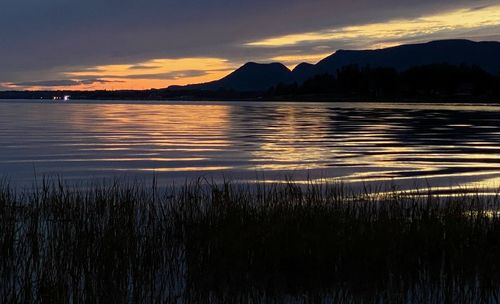Scenic view of lake against sky during sunset