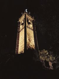 Low angle view of illuminated tower against sky at night