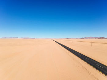 Drone - straight b4 desert road and train line between lüderitz and keetmanshoop in namibia, africa.