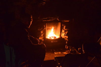 Lit candle in dark room