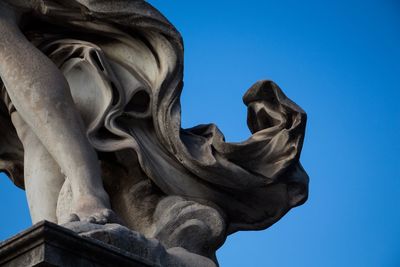 Low angle view of angel statue against clear blue sky