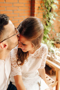 High angle view of man kissing girlfriend